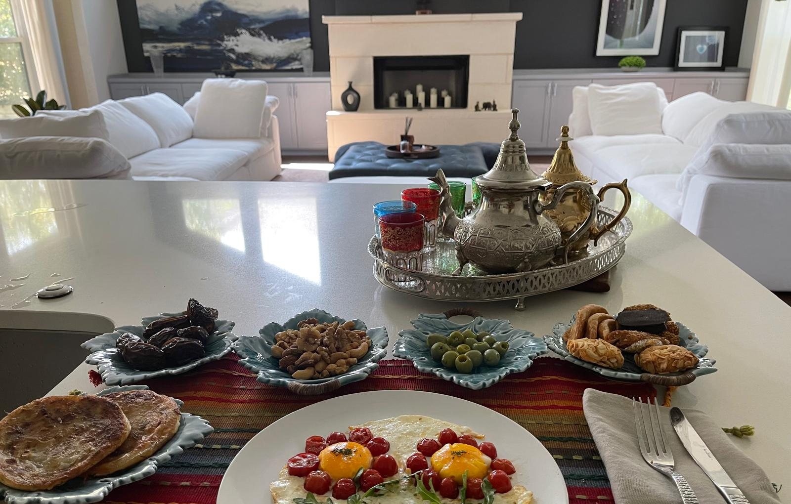 Moroccan breakfast in Austin Texas — eggs leaf plates tea service Moroccan textile